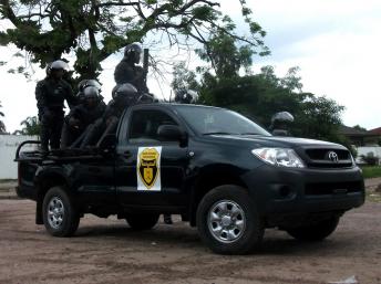 Riot police aboard a jeep in Limete, Kinshasa